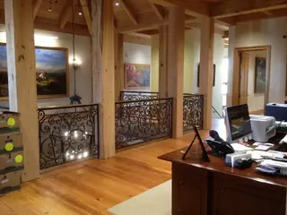 Indoor railing with large scrolls.