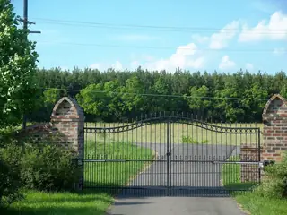 Straight gate beside a lawn.