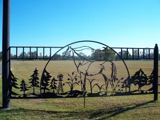 Panel with deer, trees and mountains.