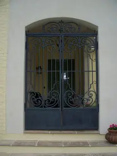 Double doors with ornamental ironwork.