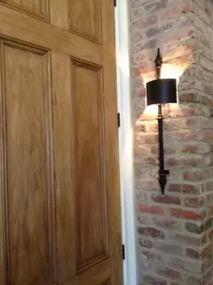 Wall light beside a wooden door.