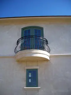 Curved balcony above a window.