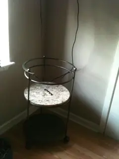 Circular stand on wheels.