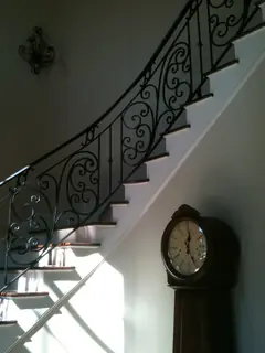 Wooden stairs with ornamental ironwork.