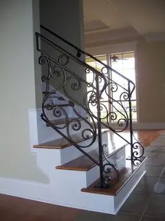 Indoor stairs with ornamental railing.