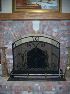 Arched screen in front of brickwork.