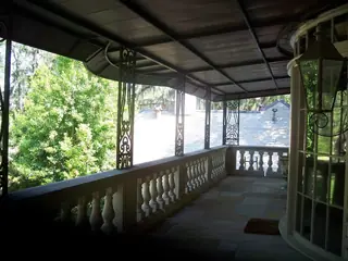 Covered veranda among trees.