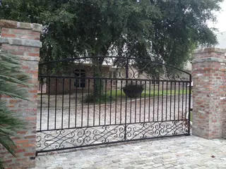 Wide gate between brick pillars.
