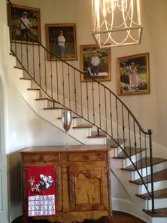 Wooden stairs and iron railing.