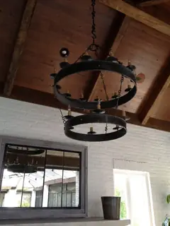Circular light beneath a timber ceiling.