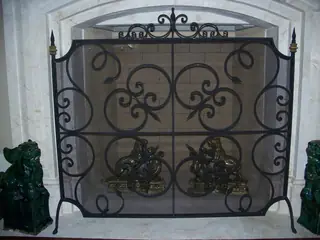 Fireplace screen with large scrolls.