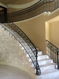 Curved stairs with pale treads.