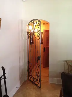 Narrow door with scrollwork.