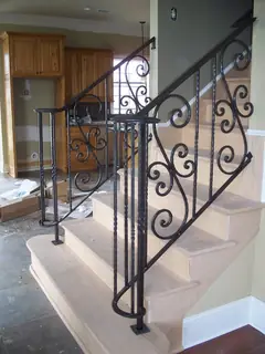 Scrollwork beside pale steps.