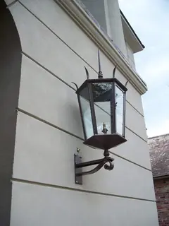 Outdoor lantern on a curved bracket.