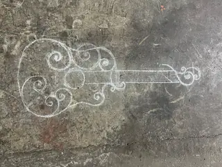 Guitar drawn in chalk.