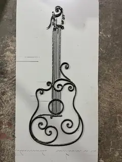 Metal guitar on a sheet.