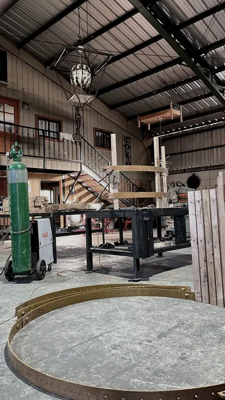 Workshop interior with tools, machinery and a mezzanine.